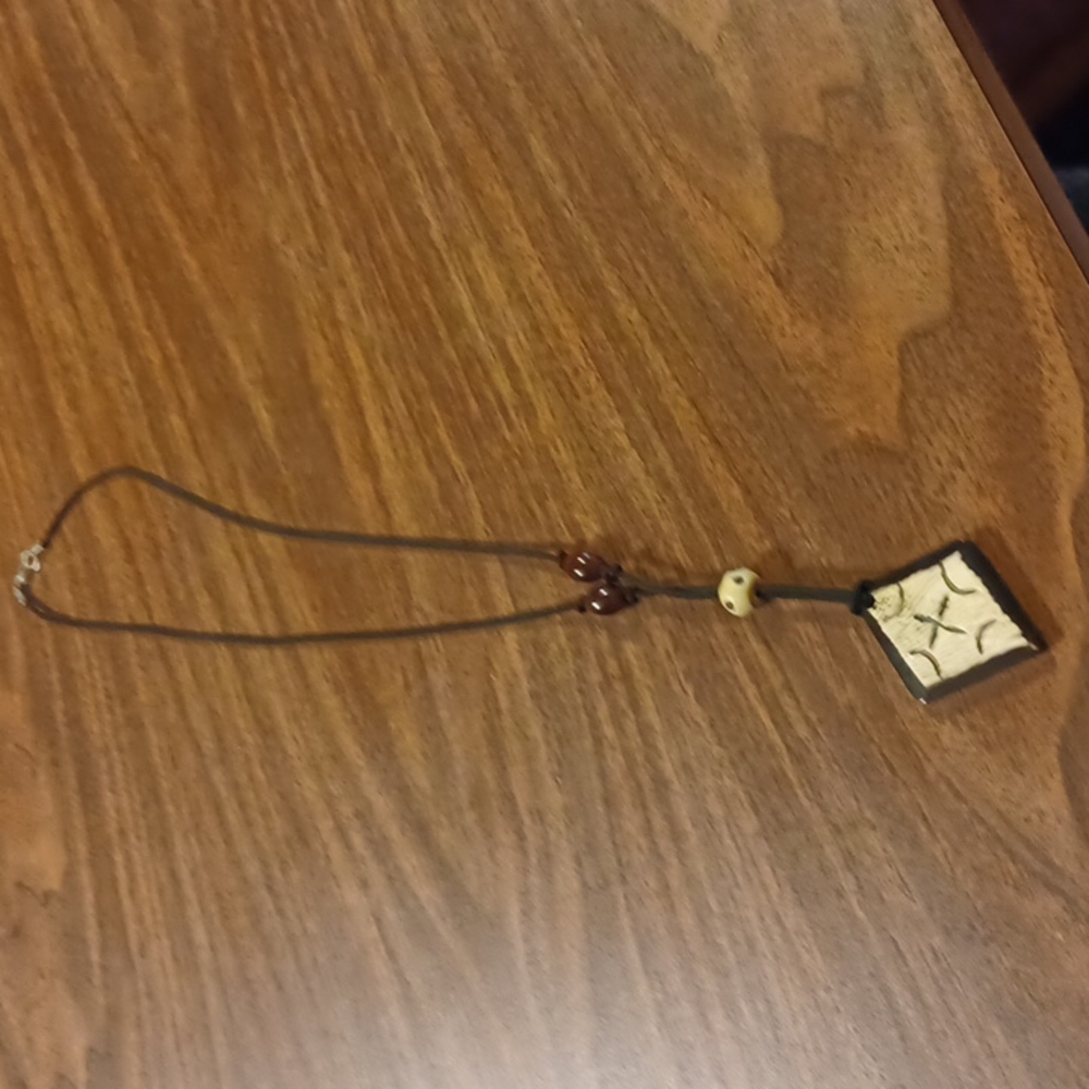 3/$10. 38in cord necklace with Woodenbeads and Medallion.